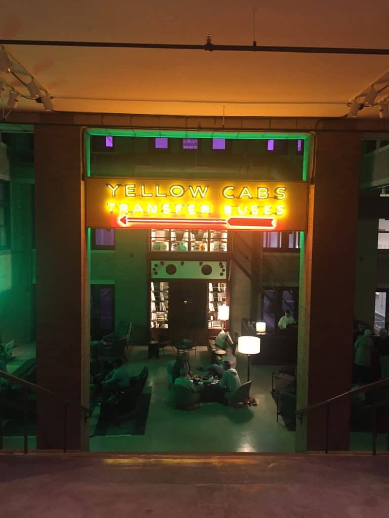 the lobby at Central Station in Memphis bathed in green and red neon light with its old Yellow Cabs sign