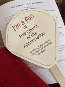 A paper fan announcing I'm a fan of Free Church of the Annunciation, which is where I started thinking about releasing those we love to God