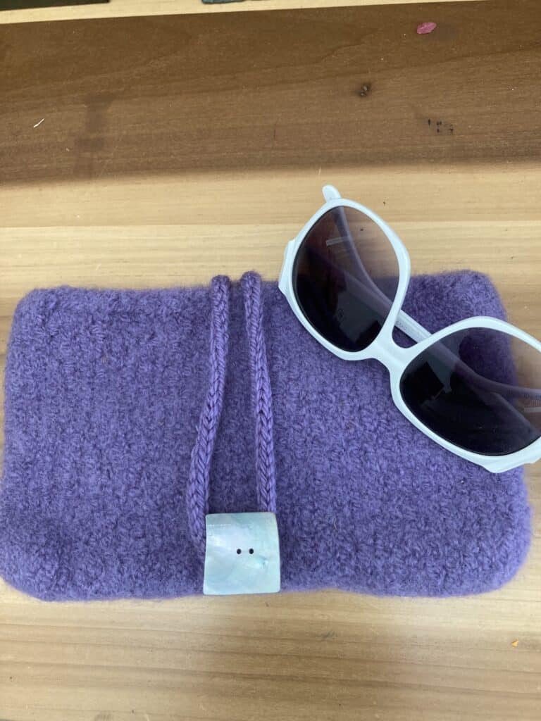 Lavender hand-kitted clutch with white sunglasses just scream Happy New Year