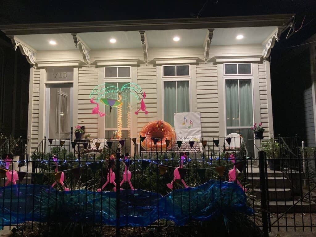 Night view of "Cheeseburger in Paradise" display with pink flamingos, neon sacred palm, and a big donut-like cheeseburger, that looks marvelous not that I'm not feeling puny
