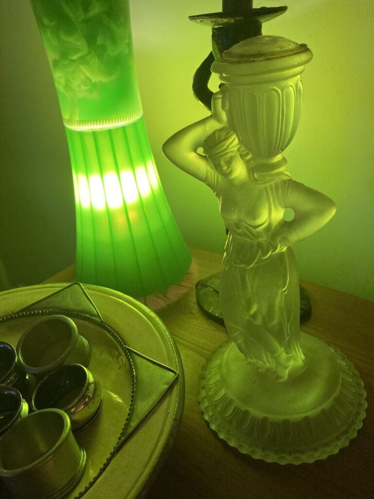 A green Lava lamp beside a Lalique glass maiden to represent my way of talking: slightly MadLibbed