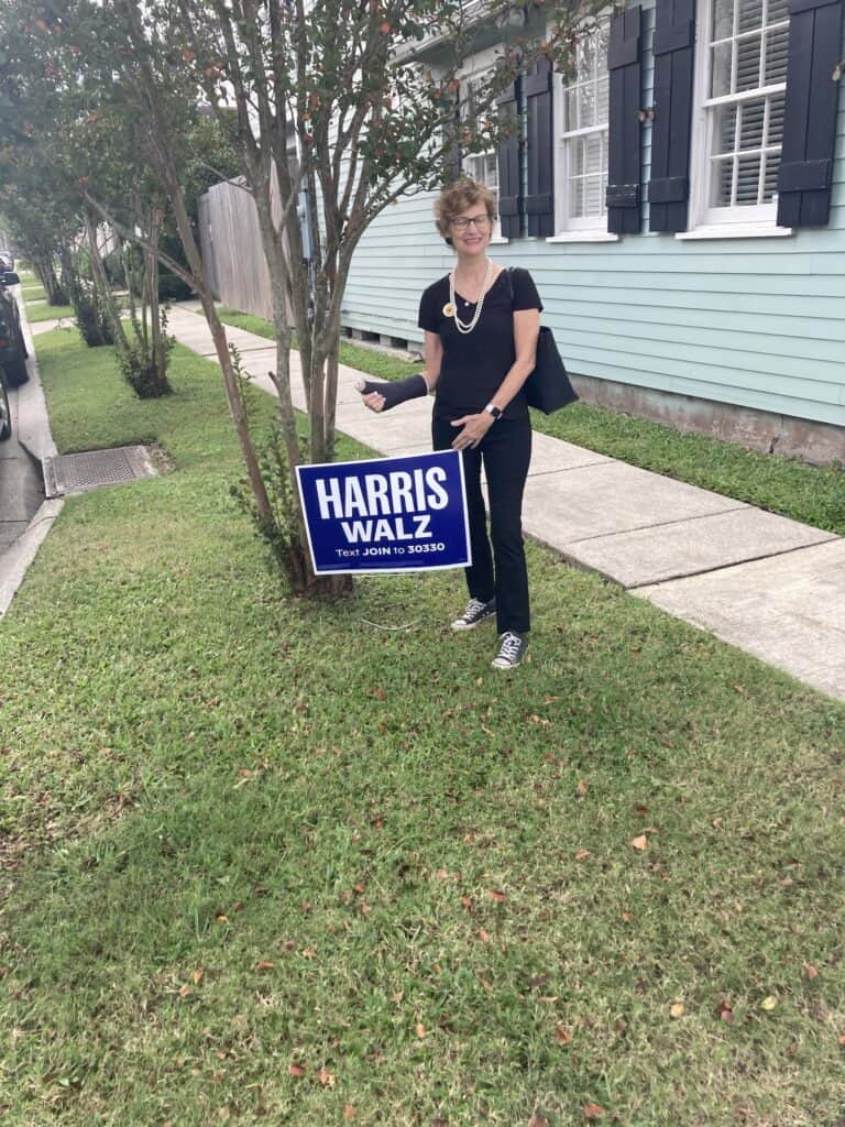 Me in my pearls and Chucks and black pants and tee in front of a Harris sign as I voted today. 