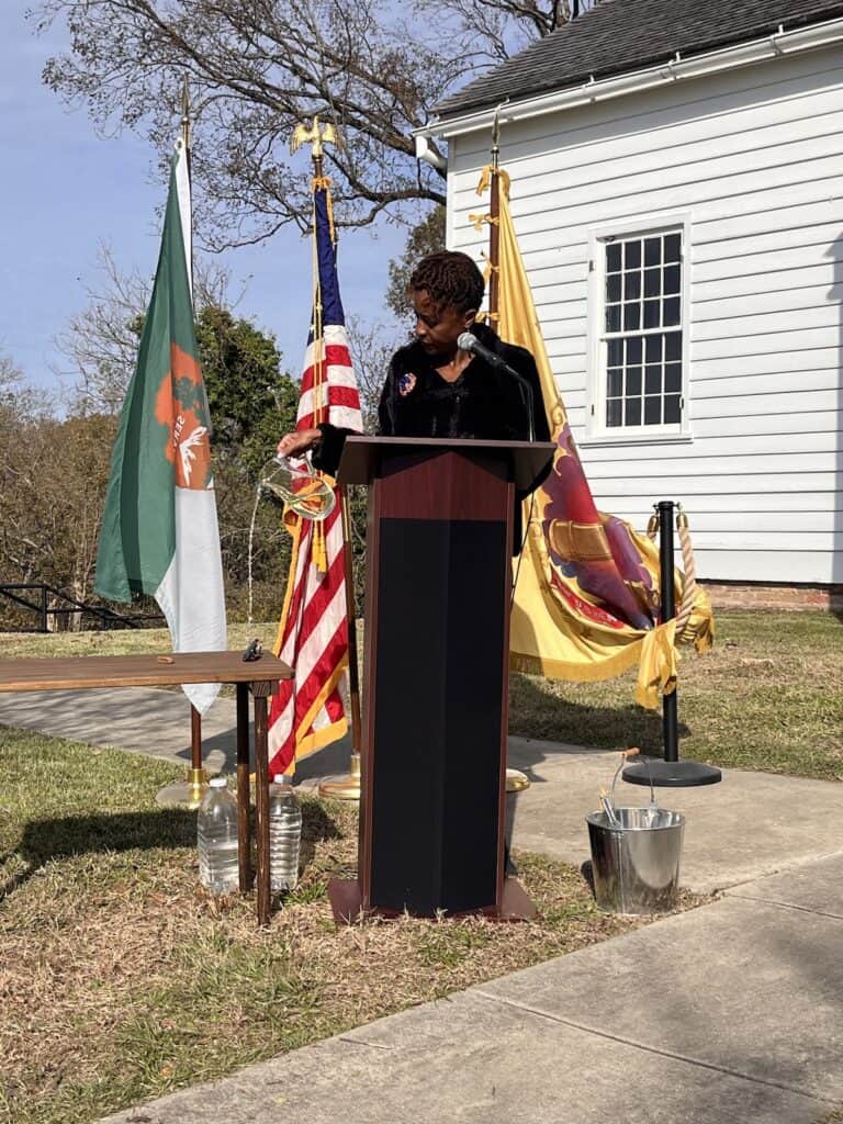 Judge Hardwick pouring water for the Libation Ceremony