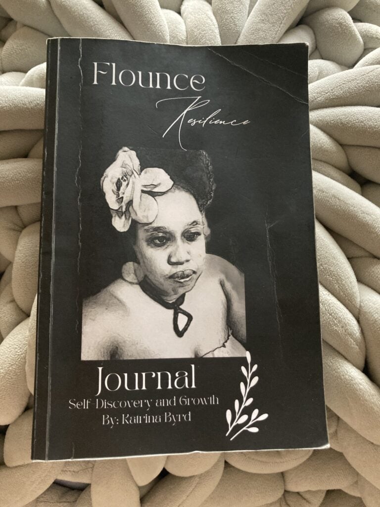 The cover of Katrina Byrd's Flounce Resilience Journal featuring a selfie of Katrina with a magnolia in her hair.