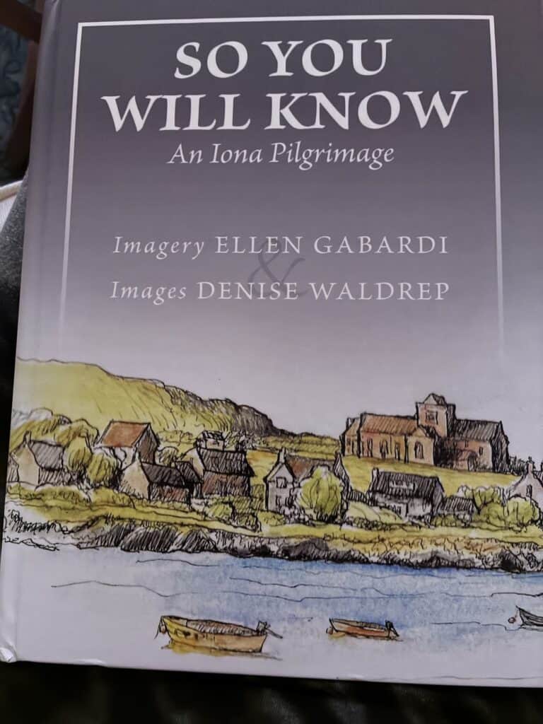 Book cover of So You Will Know showing a modest abbey by a seashore with small buildings huddled along the shore, the water blue
